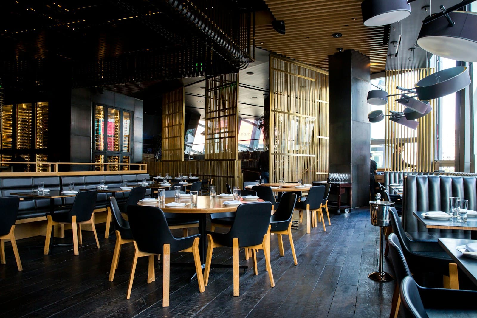 Warm restaurant dining room with wooden chairs